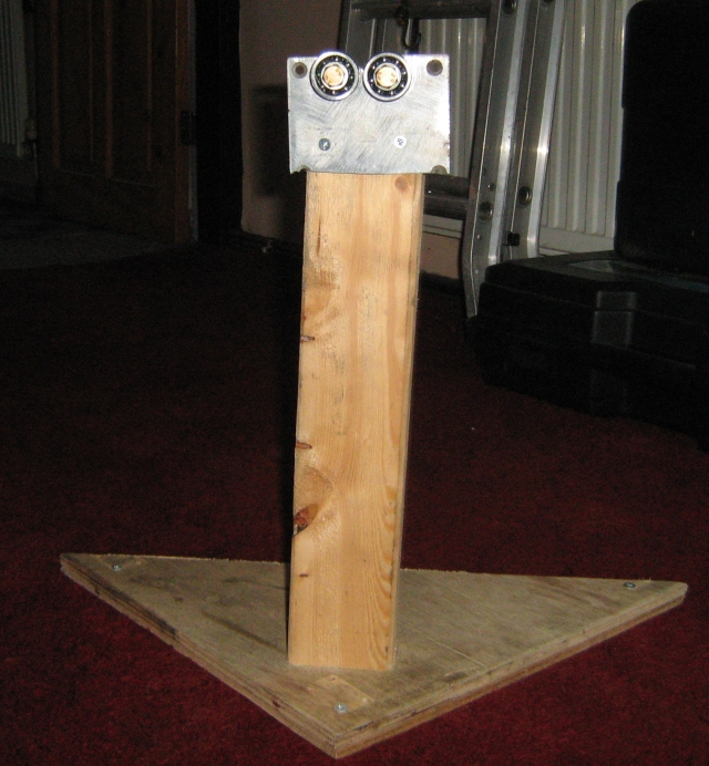the plate with the bearings on mounted to a pice of wood upright on a flat board
